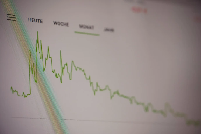 A green line graph showing stock market trends on a digital screen